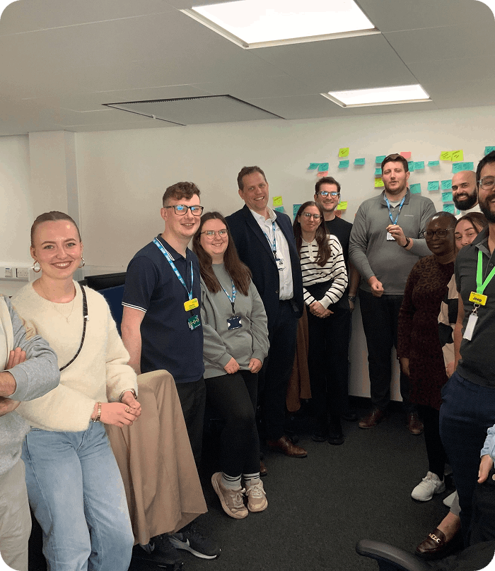 Group of people with postit notes behind them